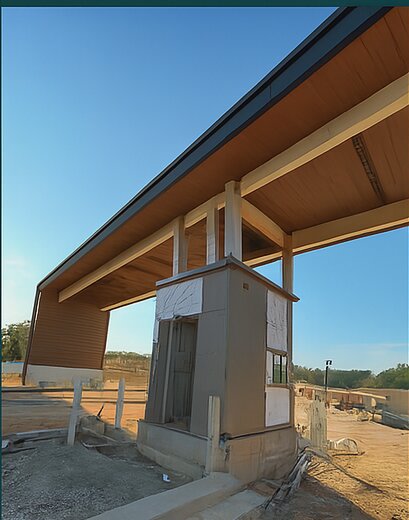 Steel building overhang with standing seam roofing